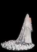 Long white wedding veil with floral details on a black background
