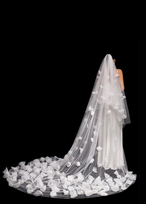 Long white wedding veil with floral details on a black background