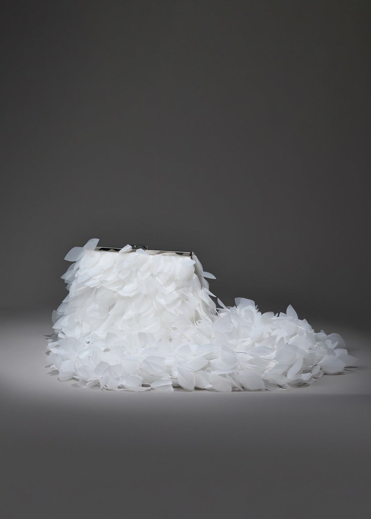 White shoe made of small crystals on a dark gray background