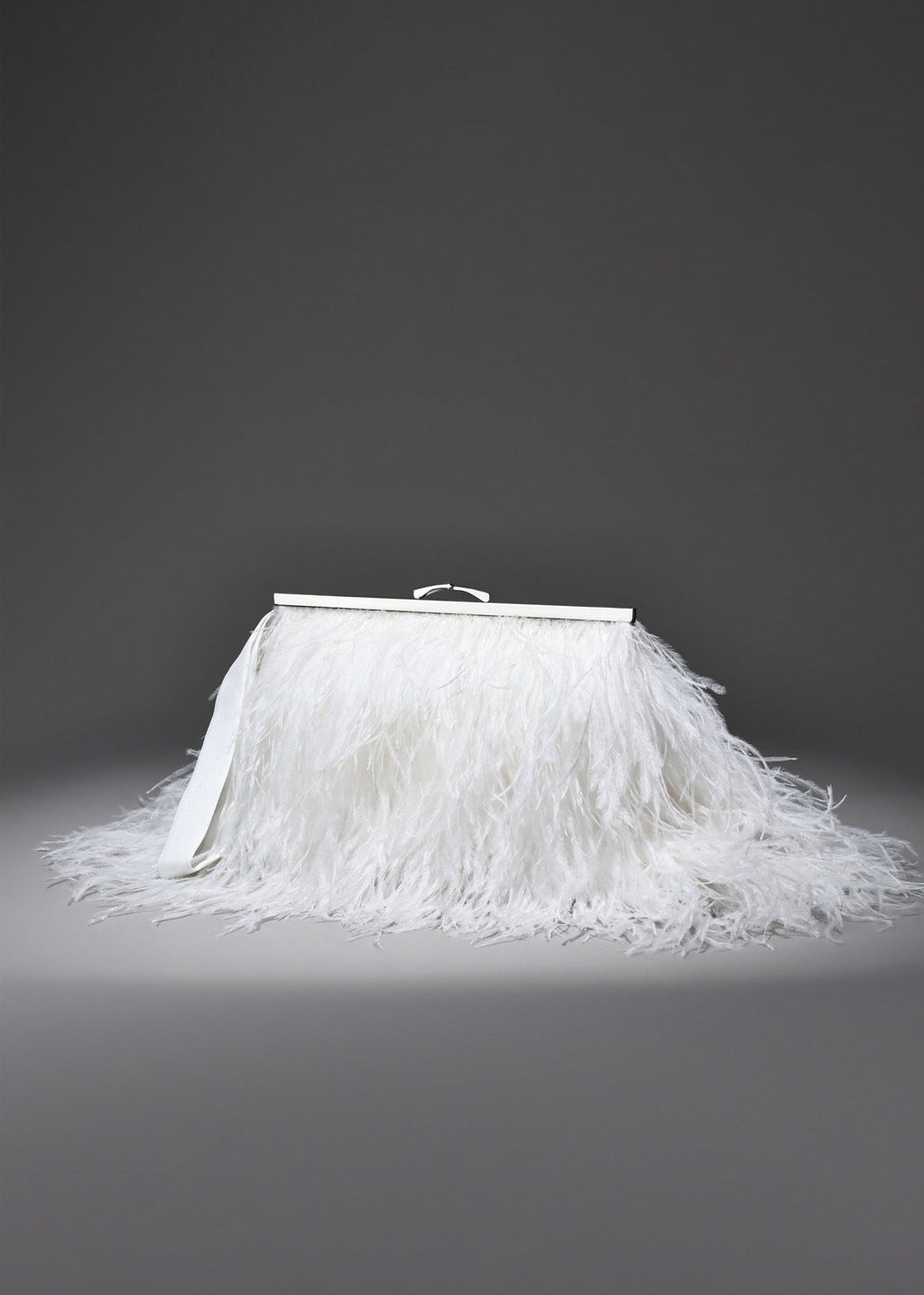 White feathered skirt with a silver frame on a gray background