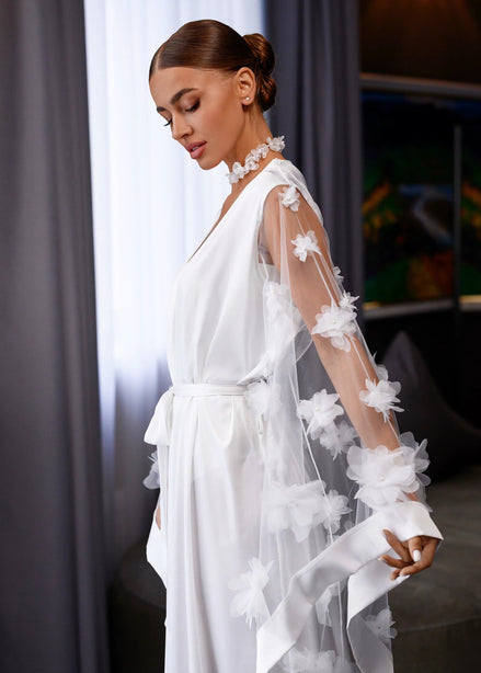 Woman wearing a white floral dress in an indoor setting