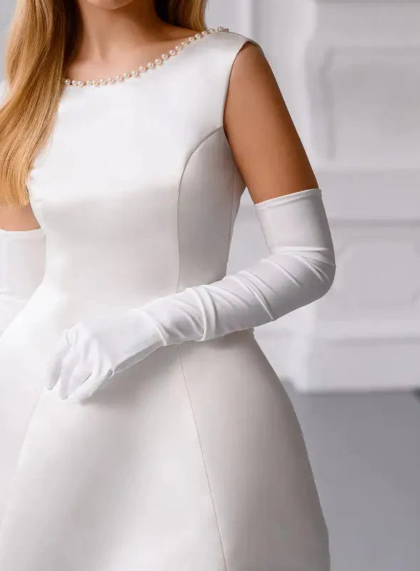 White dress with long gloves on a plain background