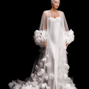 White wedding dress with floral details on a black background